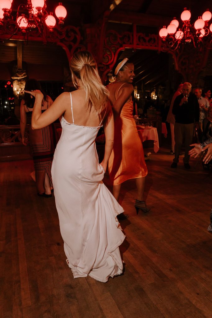 Lily dancing with a friend at her rehearsal dinner