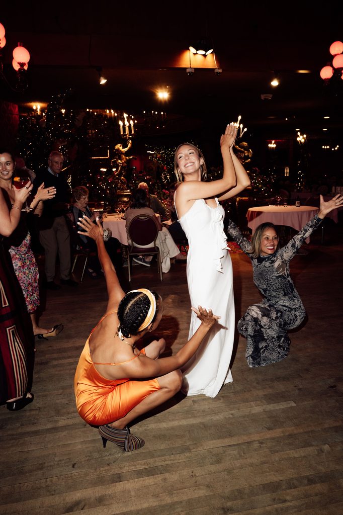 Lily laughing on the dance floor during her rehearsal dinner