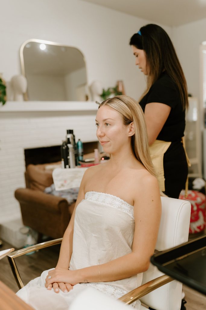Lily having her makeup done before her wedding at The Penny