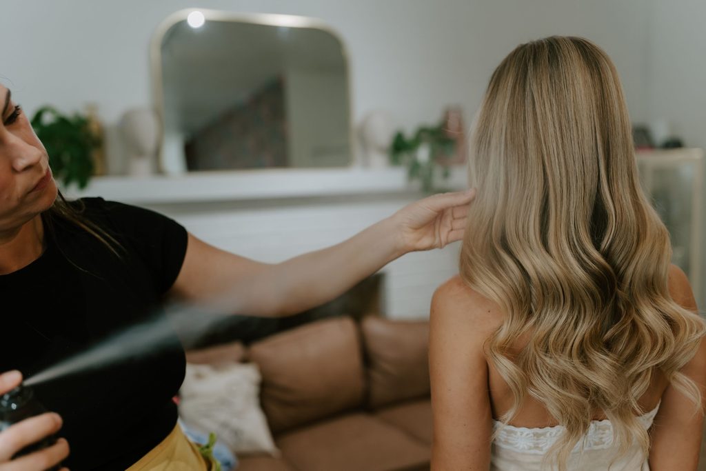Lily having her hair styled before the wedding