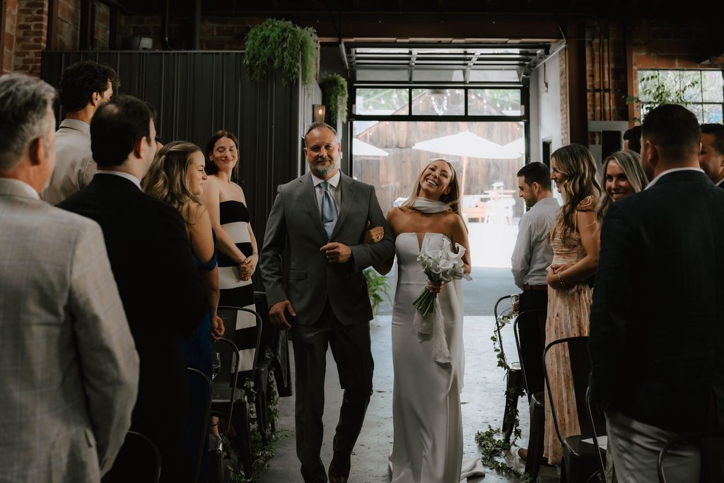 Lily and her father entering the wedding ceremony at The Penny
