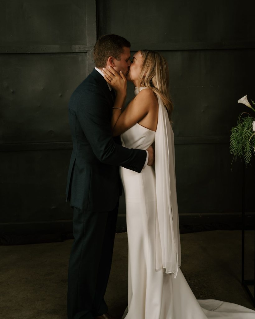 Lily and Ryan kissing after their wedding ceremony