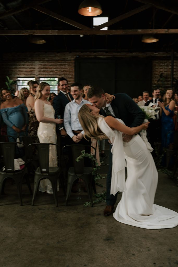 Lily and Ryan sharing a quiet kiss after their ceremony