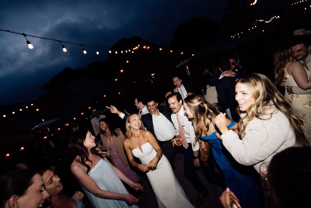 Guests cheering on the dance floor at The Penny wedding reception