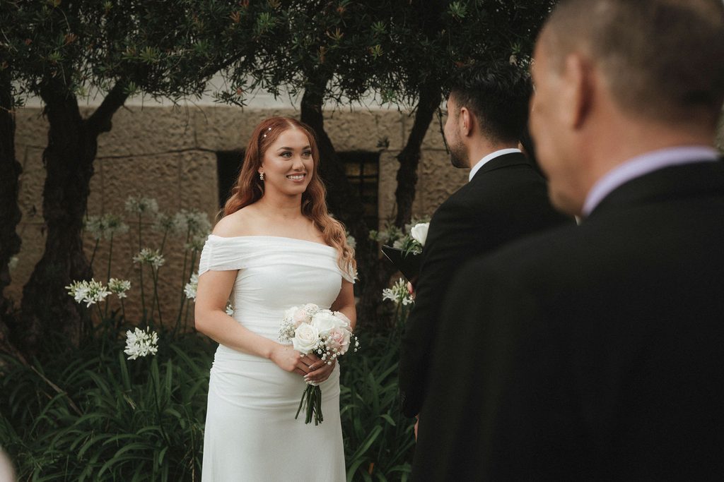 Vanessa smiling at Bryant during their courthouse ceremony