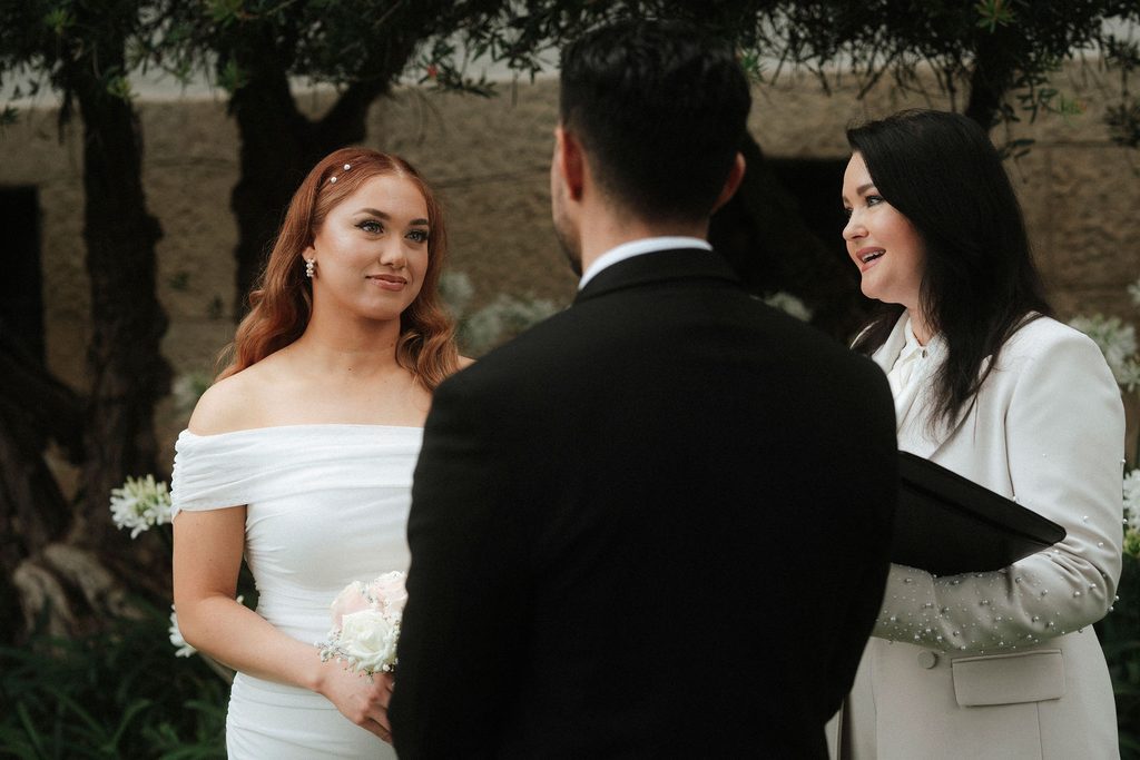 Vanessa and Bryant exchanging vows in the courthouse garden
