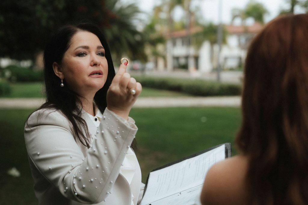 Wedding officiant speaking during Vanessa and Bryant's ceremony