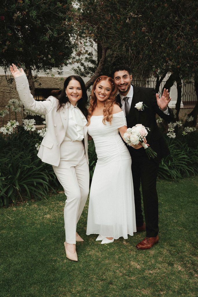 Vanessa and Bryant celebrating with their officiant after the ceremony
