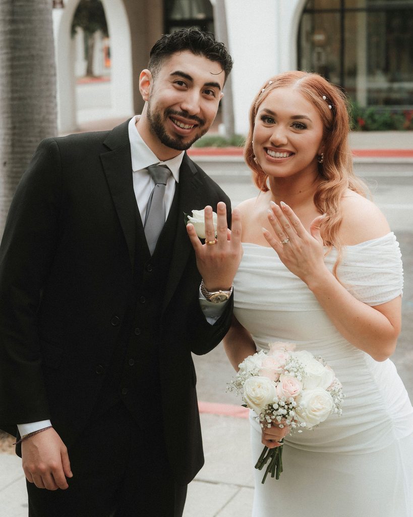 Vanessa and Bryant showing their wedding rings after the ceremony