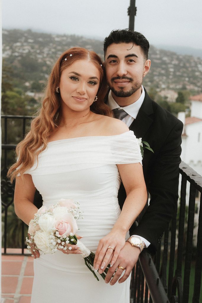 Vanessa and Bryant posing on a balcony above Santa Barbara