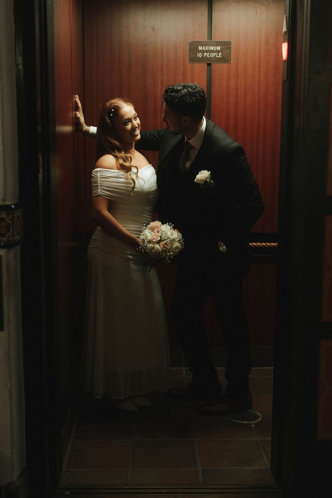 Vanessa and Bryant sharing a quiet moment inside an elevator