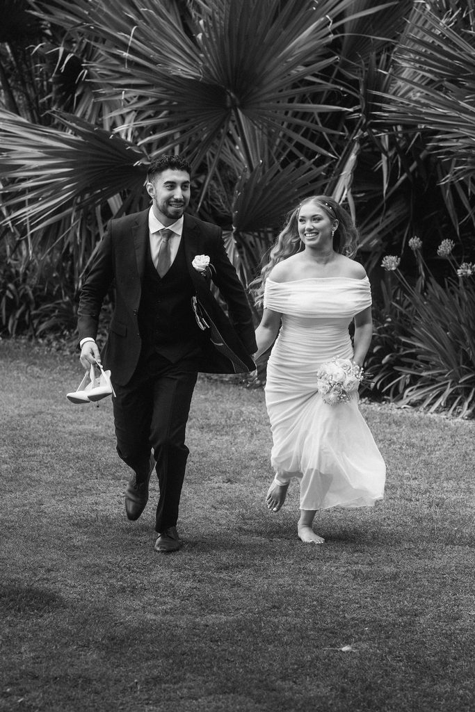 Black-and-white portrait of Vanessa and Bryant running across the courthouse lawn