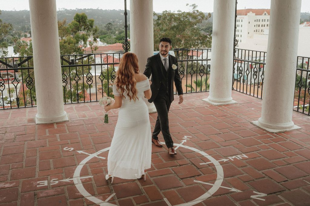 Vanessa and Bryant walking across the courthouse compass balcony