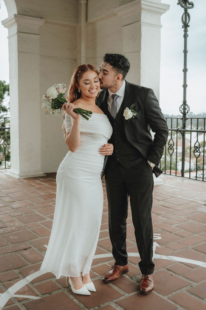 Vanessa and Bryant embracing above the Santa Barbara skyline
