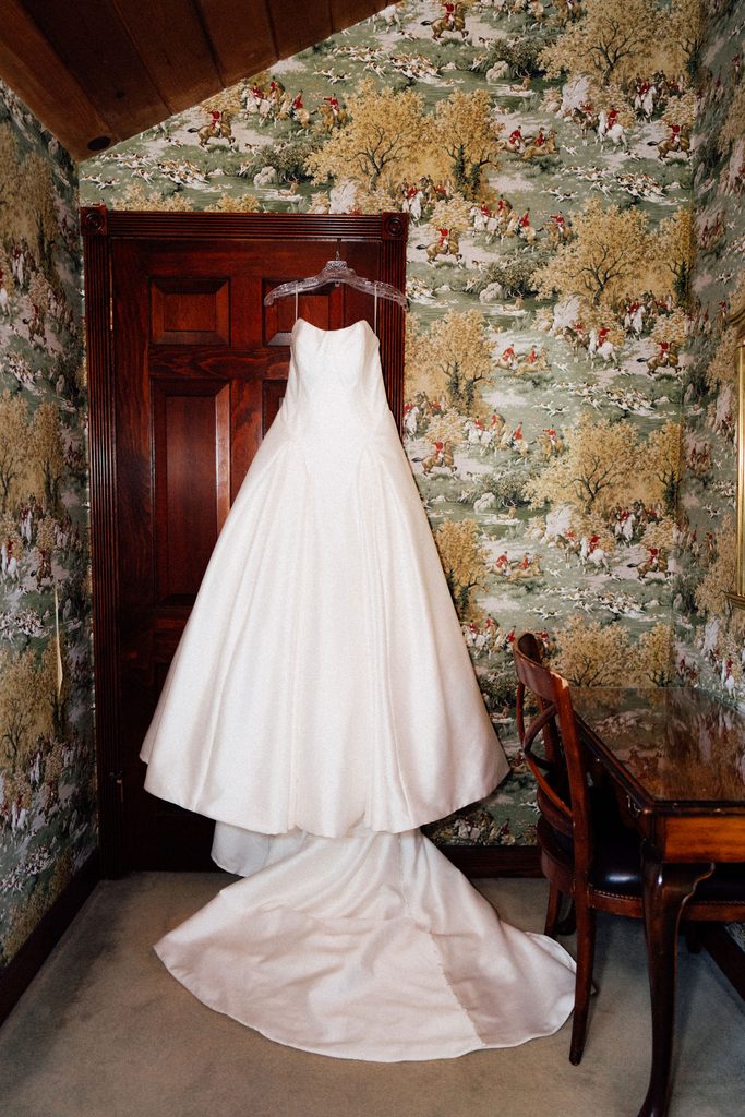 Wedding dress hanging in a stone-walled room at the Madonna Inn