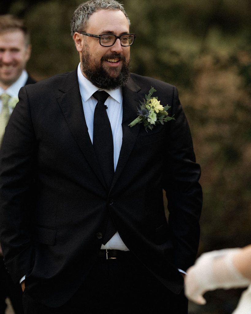 Tracy smiling before his outdoor Madonna Inn wedding ceremony