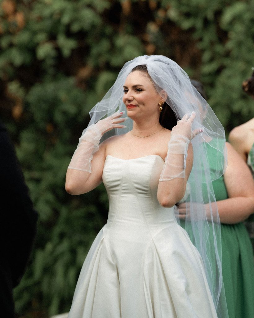 Catie adjusting her veil before the wedding ceremony