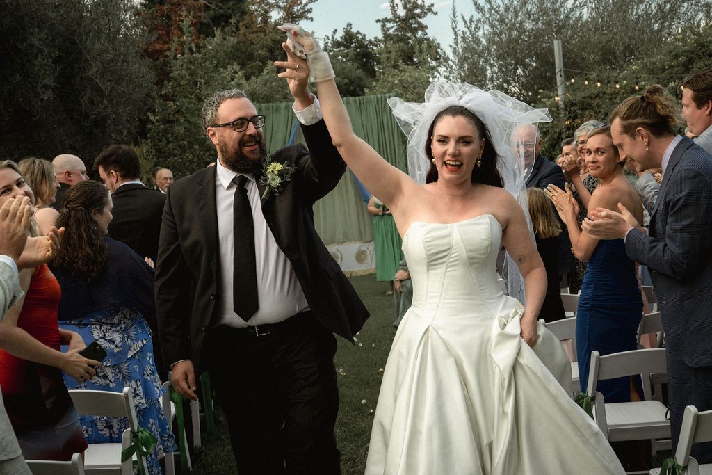 Catie and Tracy celebrating as they walk back up the aisle