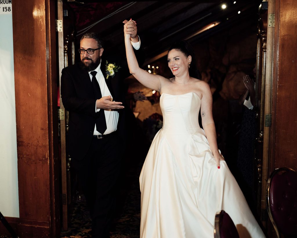 Newlyweds entering their Madonna Inn wedding reception
